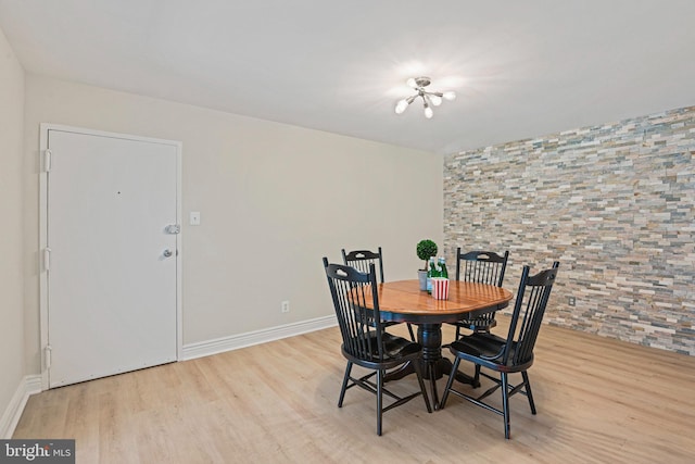 dining area featuring baseboards and wood finished floors