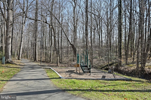 view of community with playground community and a view of trees
