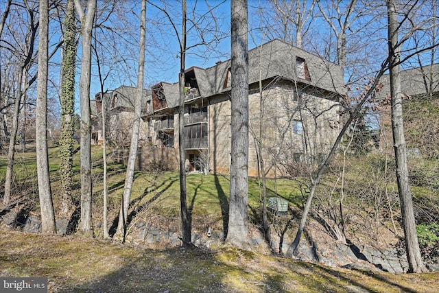 view of home's exterior with a shingled roof