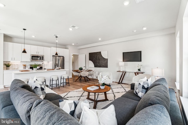 living room with light hardwood / wood-style flooring