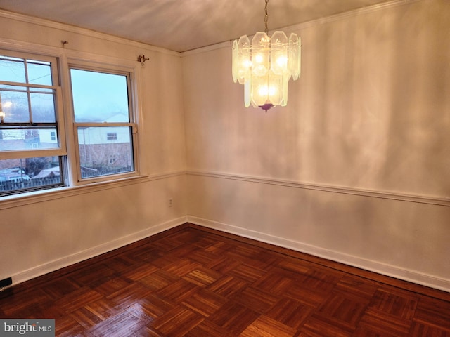 empty room featuring a notable chandelier and dark parquet flooring