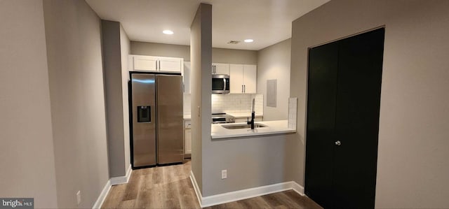 hallway featuring sink and hardwood / wood-style floors