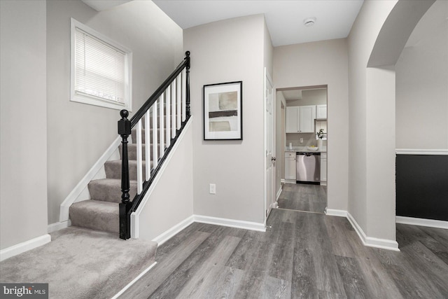 staircase with hardwood / wood-style flooring