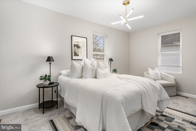 bedroom featuring an inviting chandelier and light colored carpet