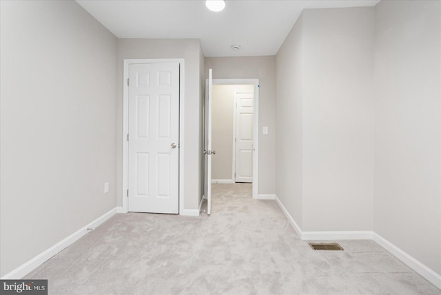 unfurnished bedroom with light colored carpet