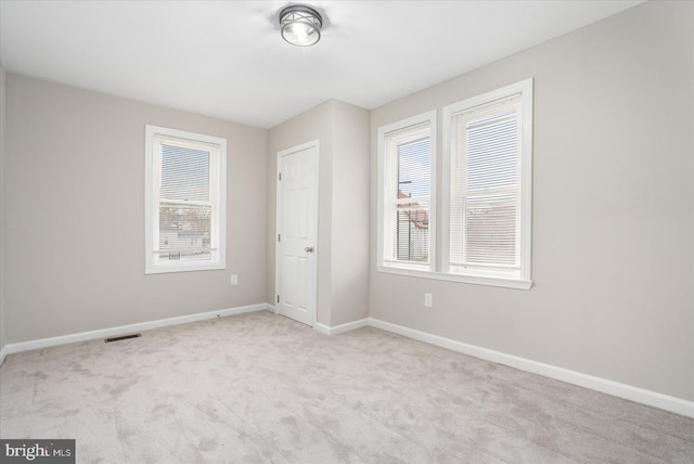 unfurnished bedroom featuring light carpet