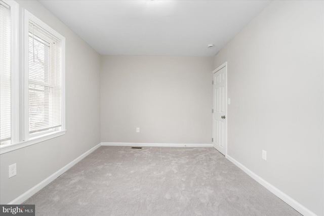 spare room with light colored carpet