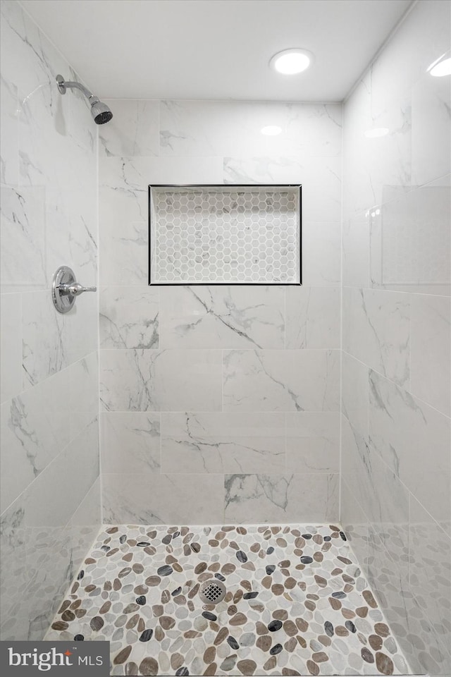 bathroom with tiled shower