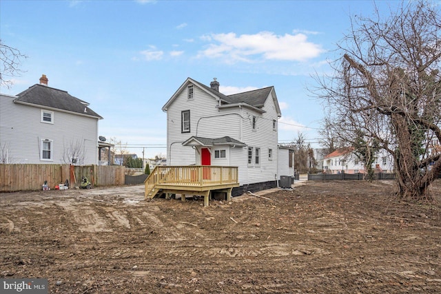 back of property with cooling unit and a wooden deck