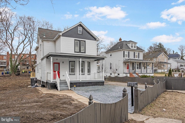 rear view of house with central AC and covered porch