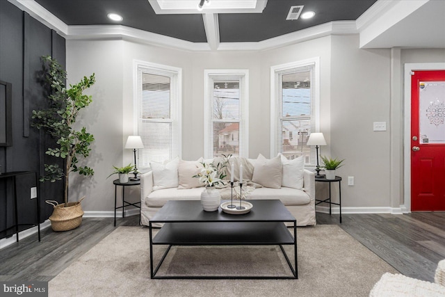 living room featuring ornamental molding, wood-type flooring, and coffered ceiling