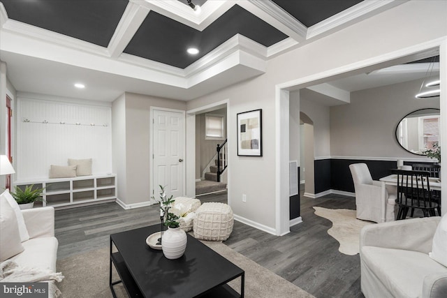 living room featuring dark hardwood / wood-style floors, ornamental molding, and coffered ceiling