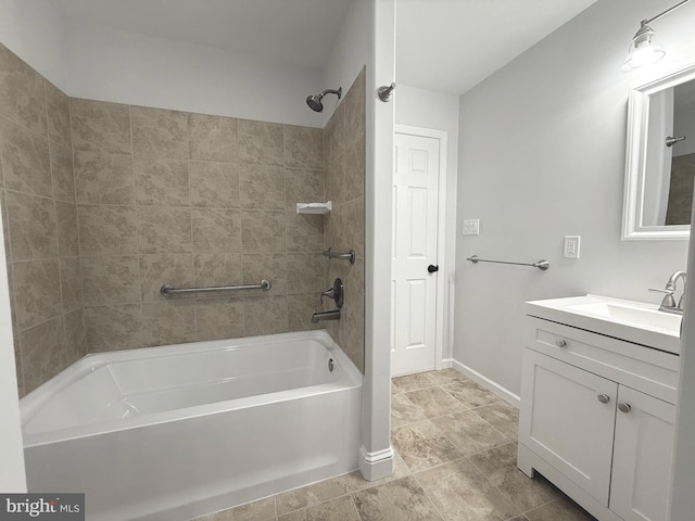 bathroom featuring tiled shower / bath and vanity