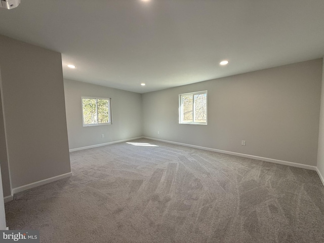 unfurnished room with a healthy amount of sunlight and carpet flooring