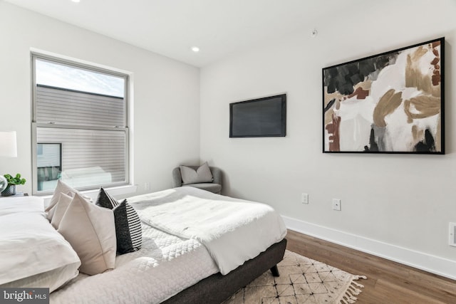 bedroom with hardwood / wood-style floors