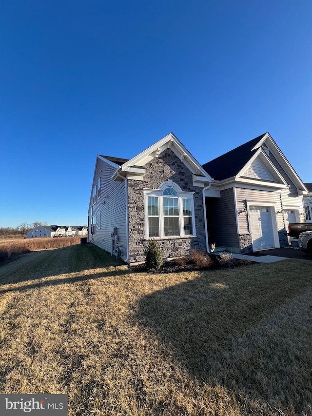 view of front facade with a garage and a front lawn