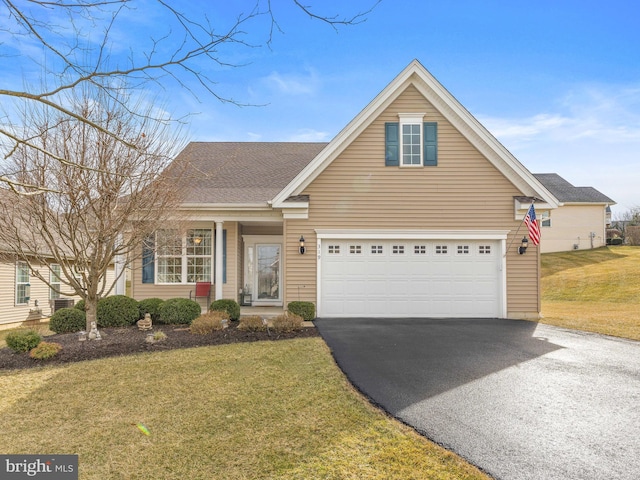 view of front of property with a garage and a front lawn