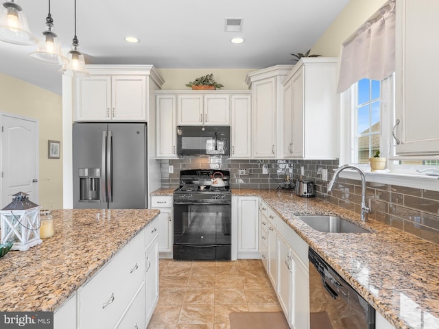 kitchen featuring decorative light fixtures, sink, white cabinets, black appliances, and light stone countertops