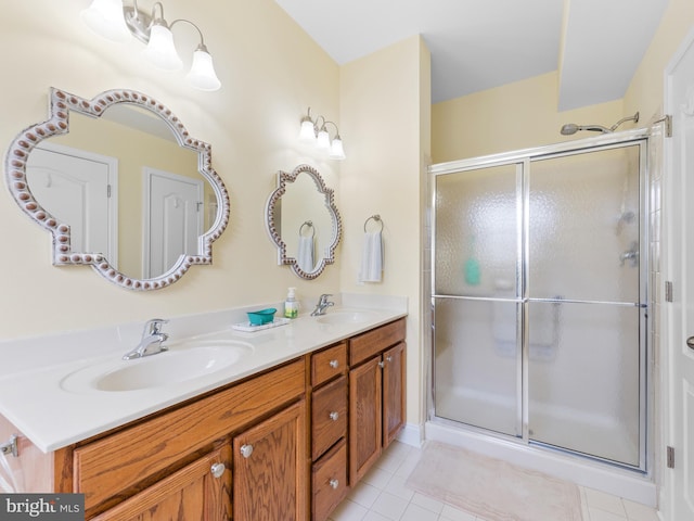 bathroom featuring tile patterned floors, vanity, and an enclosed shower