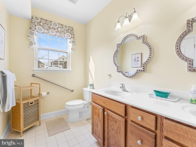 bathroom with vanity, tile patterned flooring, and toilet