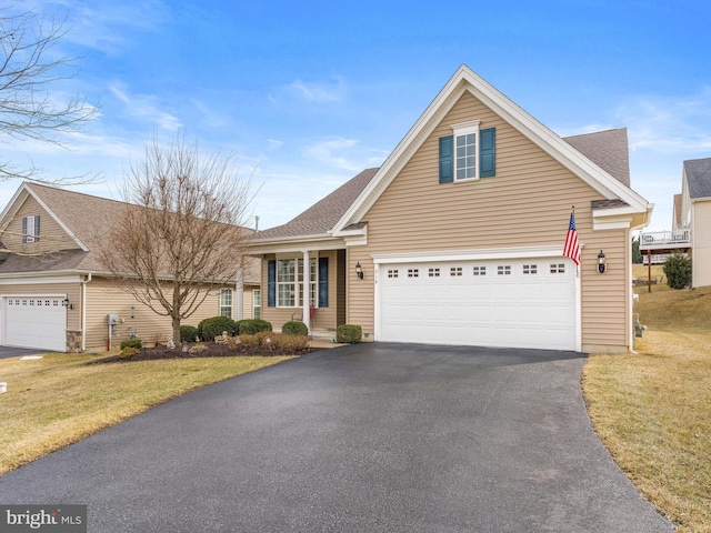 view of front of home with a garage and a front yard