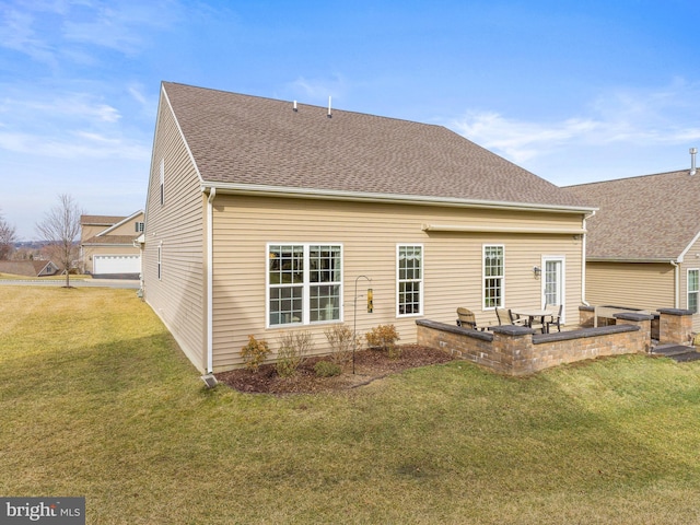 rear view of house with a yard and a patio area