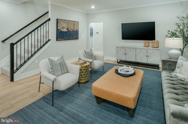 living room with wood-type flooring and ornamental molding