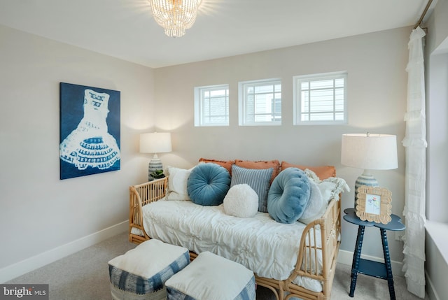 interior space featuring carpet flooring and a chandelier