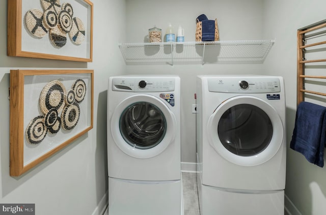 washroom featuring washer and clothes dryer