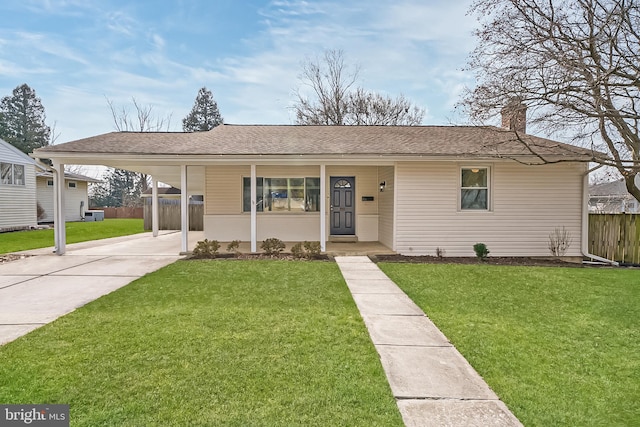 single story home featuring a front lawn and a carport