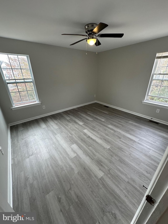 unfurnished room with wood-type flooring and ceiling fan