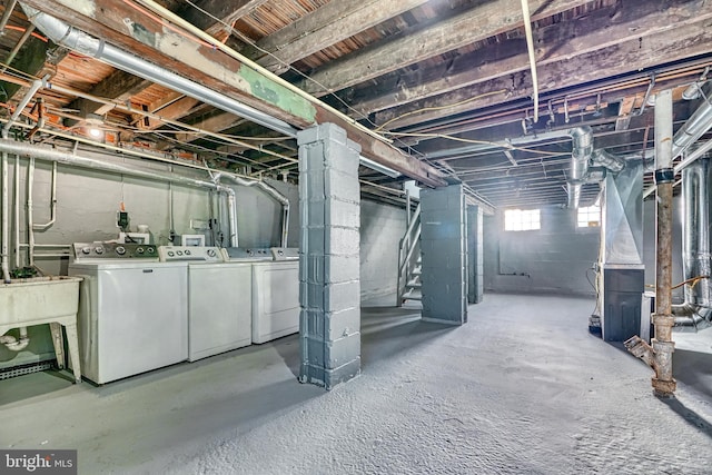 basement with heating unit and washer and clothes dryer