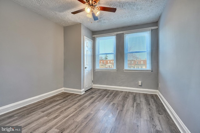 unfurnished room with hardwood / wood-style flooring, ceiling fan, and a textured ceiling