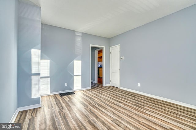 spare room with wood-type flooring