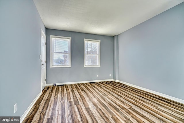 spare room with hardwood / wood-style flooring