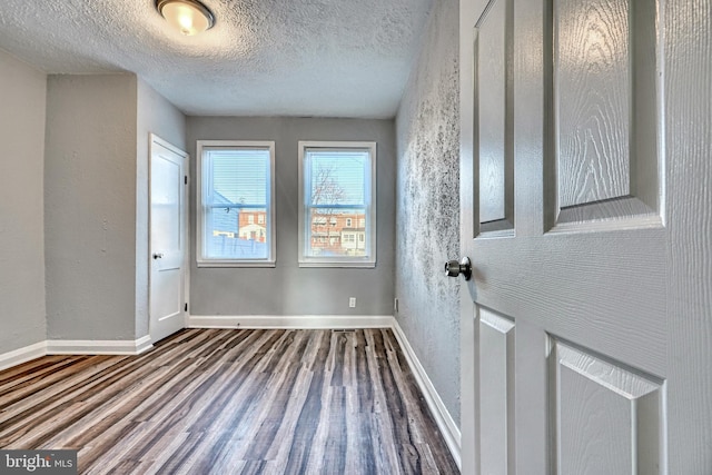 interior space with hardwood / wood-style floors and a textured ceiling