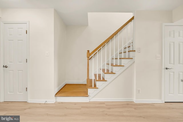 stairs with hardwood / wood-style flooring