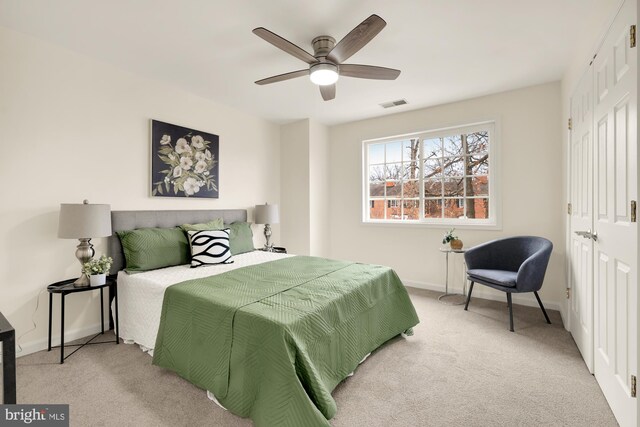 carpeted bedroom with a closet and ceiling fan