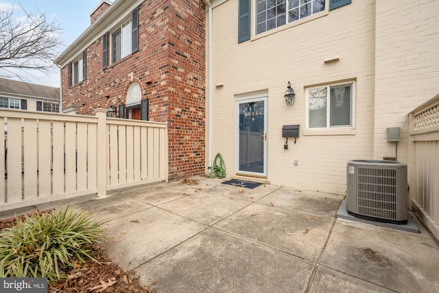 rear view of house featuring central AC unit and a patio area