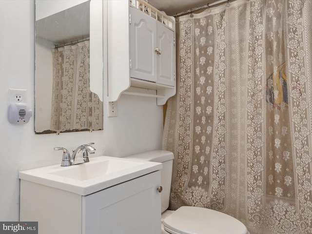 bathroom featuring toilet and vanity