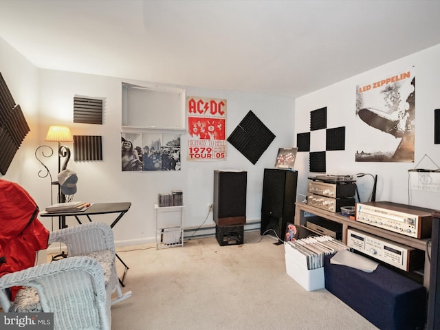 sitting room featuring baseboard heating and carpet flooring