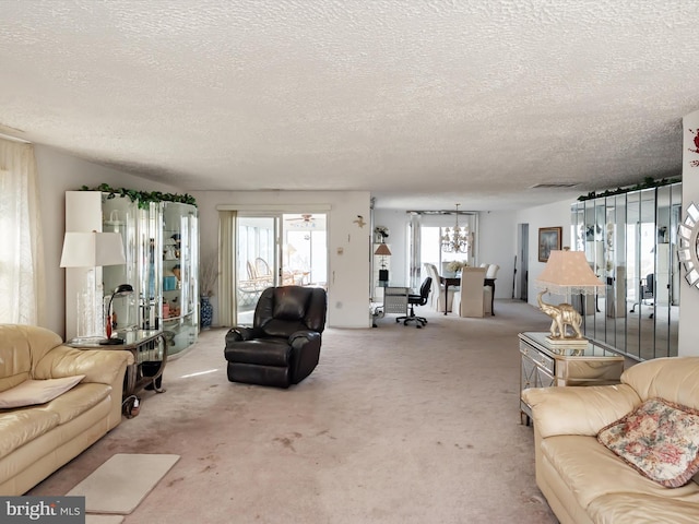 carpeted living area featuring visible vents and a textured ceiling