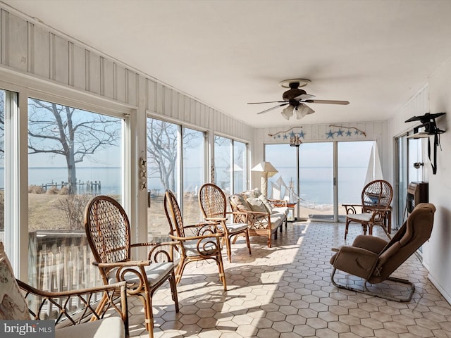 sunroom featuring ceiling fan