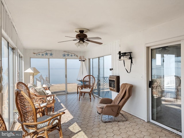 sunroom with ceiling fan and heating unit