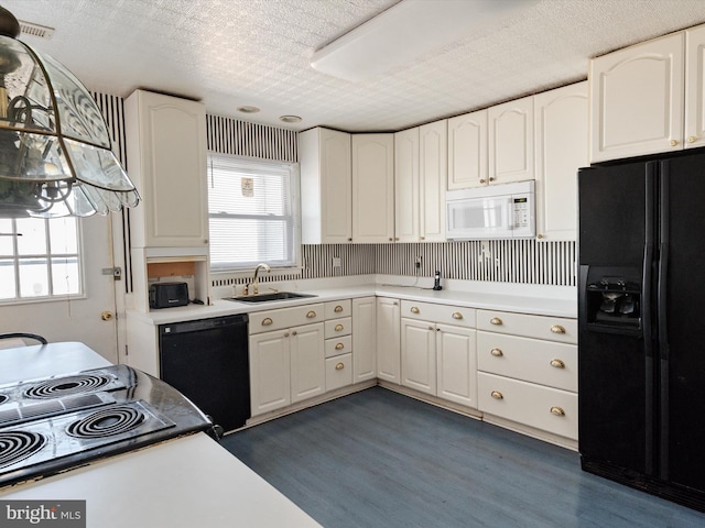 kitchen with dark wood-style flooring, light countertops, white cabinets, a sink, and black appliances