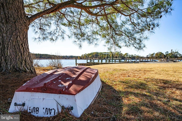 exterior space with a water view and a yard