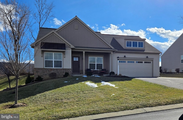 view of front of house featuring a garage and a front lawn