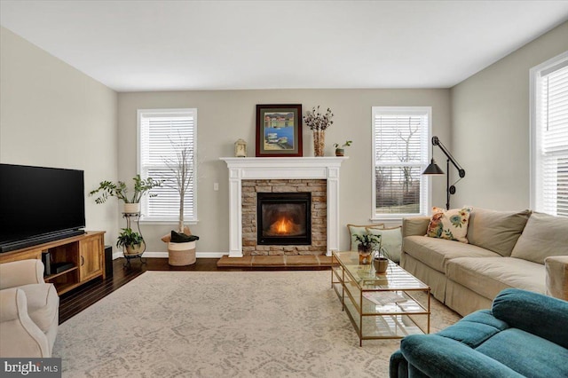 living room featuring hardwood / wood-style flooring, a healthy amount of sunlight, and a fireplace