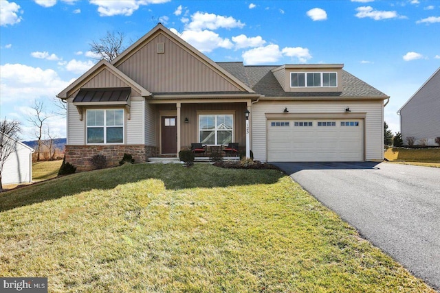 craftsman-style house featuring covered porch and a front lawn