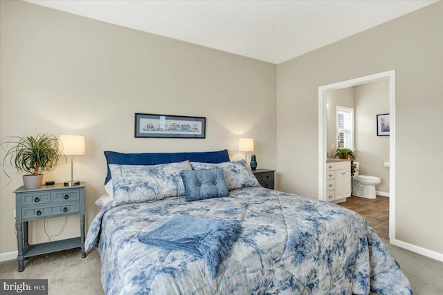 bedroom featuring ensuite bath and carpet floors